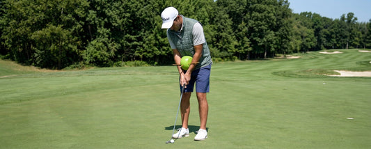 Mid handicap golfer refining their swing with a Sure-Golf training aid on the practice ground - best golf training aids for mid handicappers